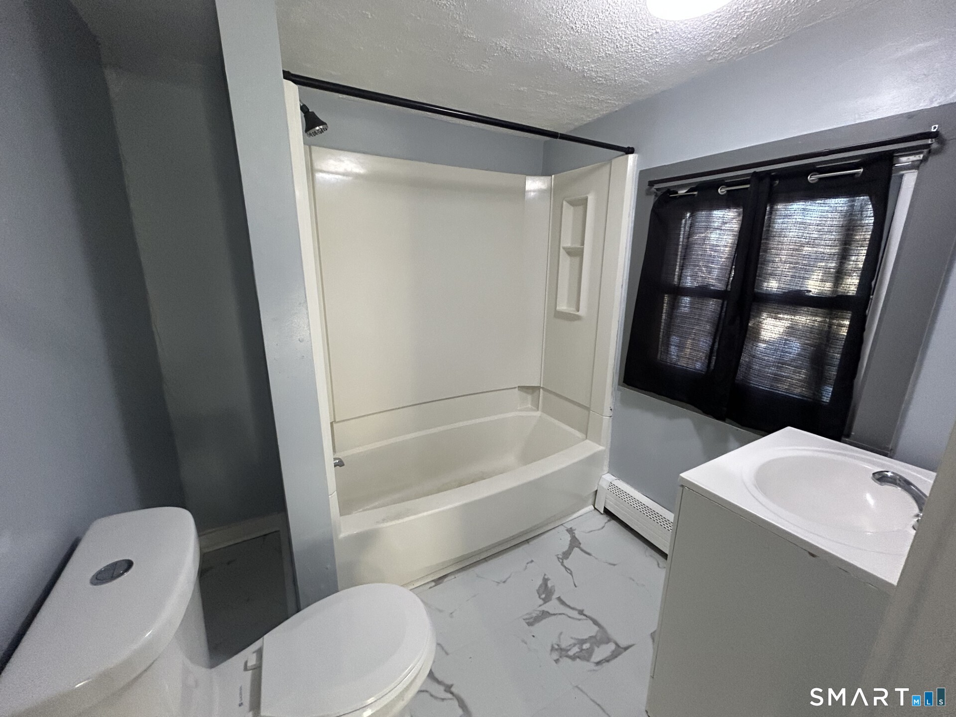 288 Litchfield Street, Unit 2 Torrington, CT 06790 - Photo 13 of 15 a bathroom with a toilet and a bathtub