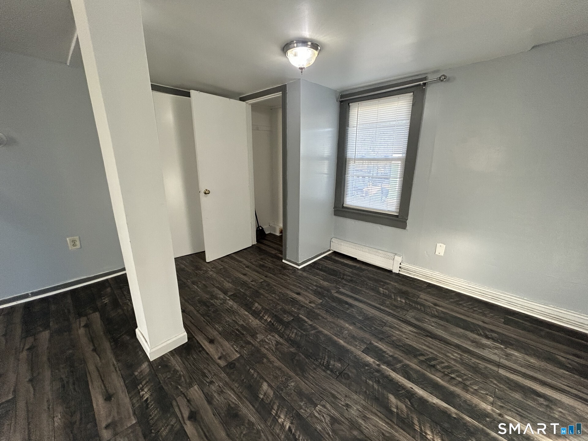 288 Litchfield Street, Unit 2 Torrington, CT 06790 - Photo 3 of 15 wooden floor in an empty room with a window