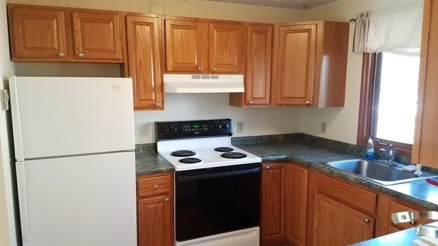a kitchen with a refrigerator and a sink