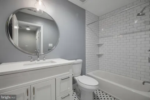 a bathroom with a sink a toilet and bathtub