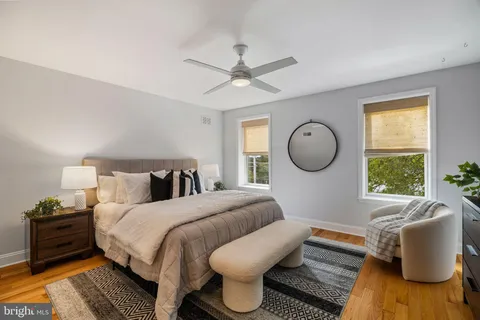 a bedroom with a bed couch and window