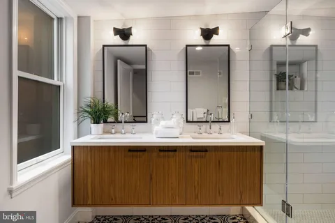 a bathroom with a double vanity sink and mirror