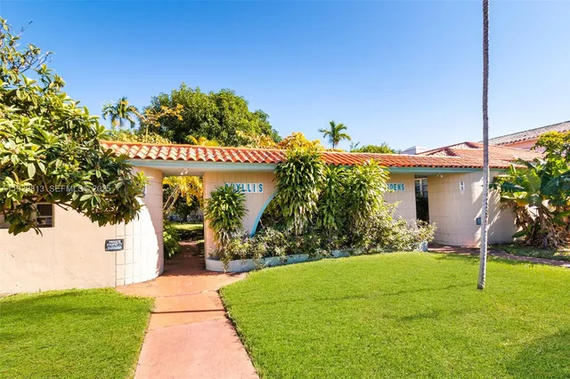 a front view of a house with a yard and a garage