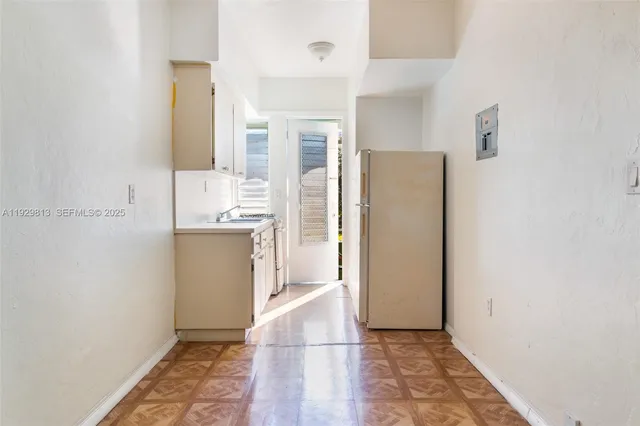 a kitchen with a refrigerator and a sink