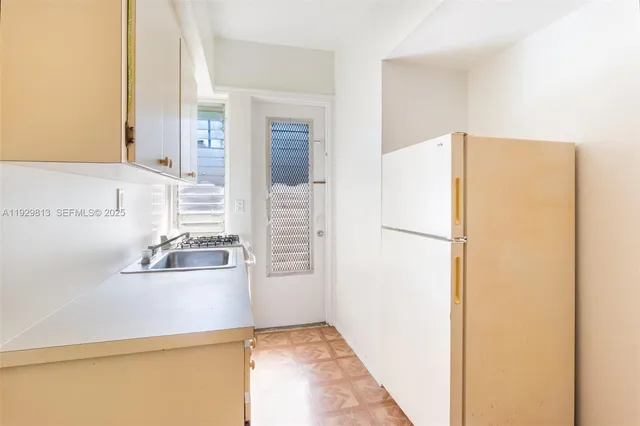 a kitchen with a refrigerator sink stove and cabinets
