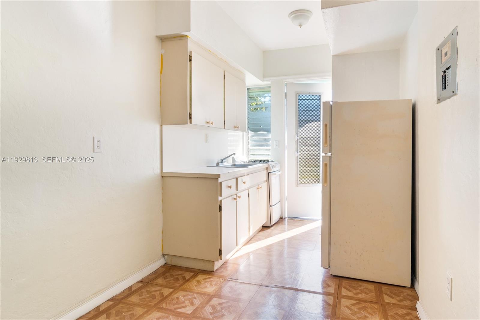 835 Alton Road, Unit 19 Miami Beach, FL 33139 - Photo 6 of 12 a kitchen with a refrigerator sink stove and cabinets