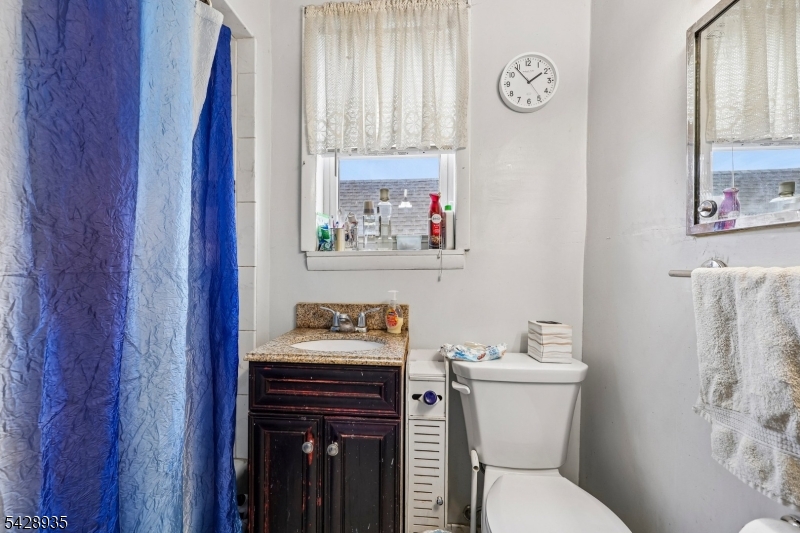 50 Preston Street Ridgefield Park, NJ 07660 - Photo 28 of 41 a bathroom with a toilet sink and mirror