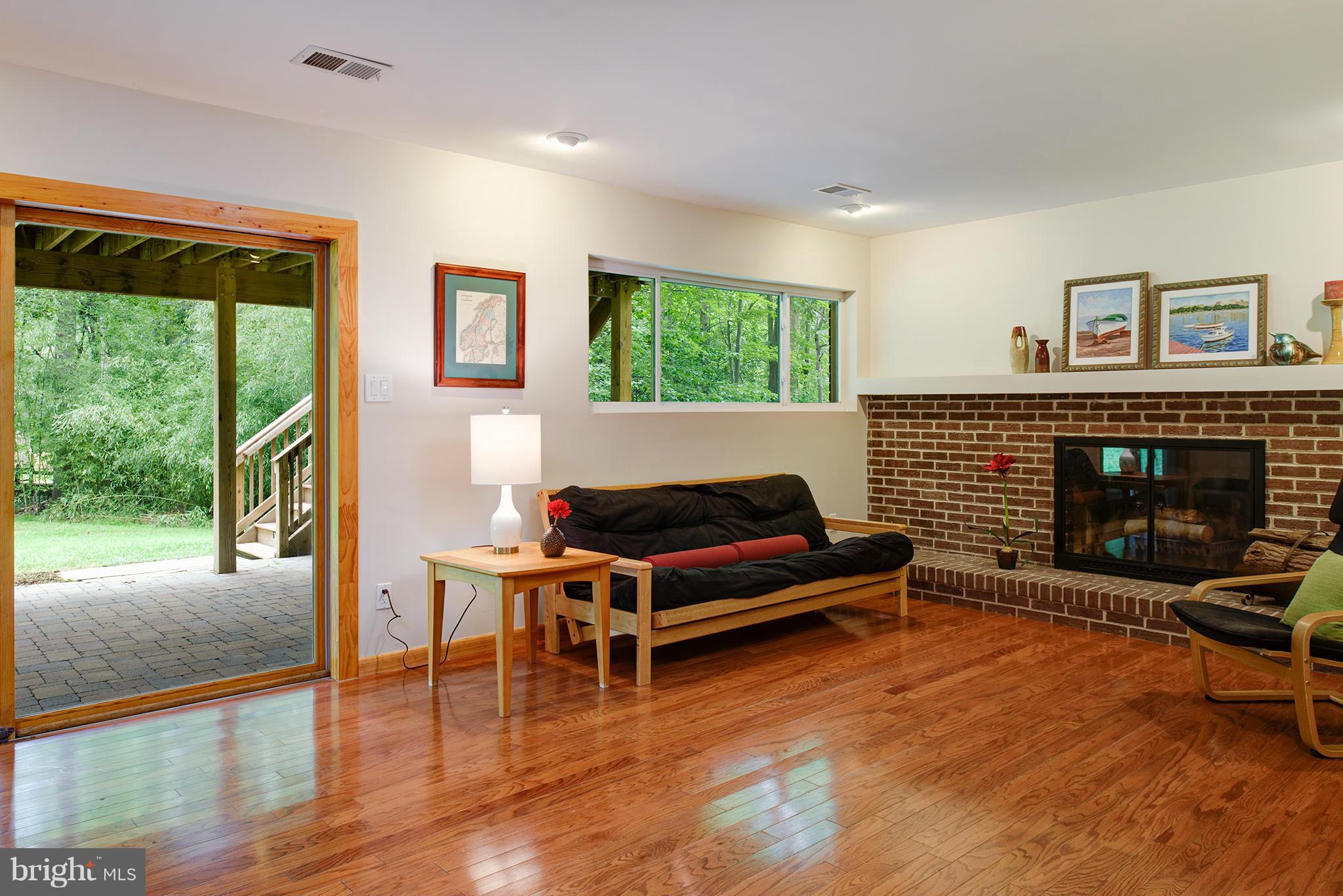 2407 Myrtle Lane Reston, VA 20191 - Photo 20 of 28 a living room with furniture a fireplace and a floor to ceiling window