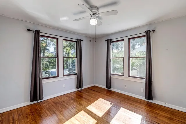 wooden floor in an empty room with a window
