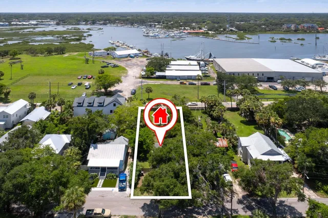 an aerial view of residential house with outdoor space and ocean view
