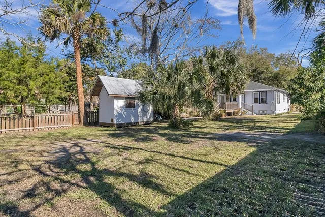 a view of balcony with wooden floor and fence