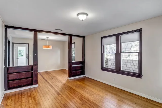 wooden floor in an empty room with a window