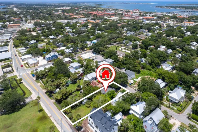 an aerial view of residential house with outdoor space and ocean view