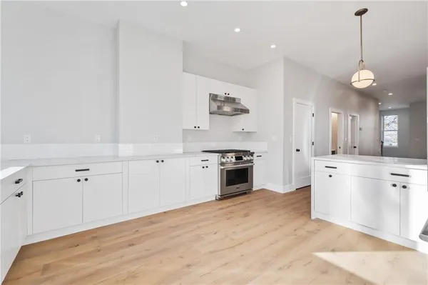 a stove top oven sitting inside of a kitchen
