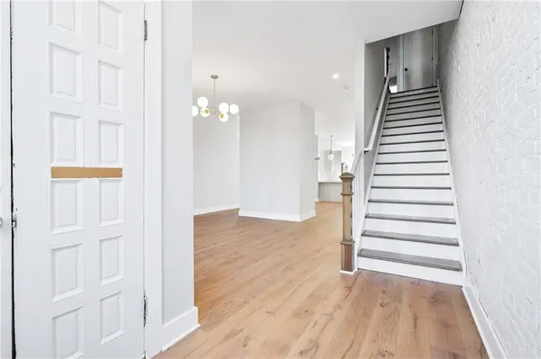 a view of a hallway with entryway wooden floor and front door
