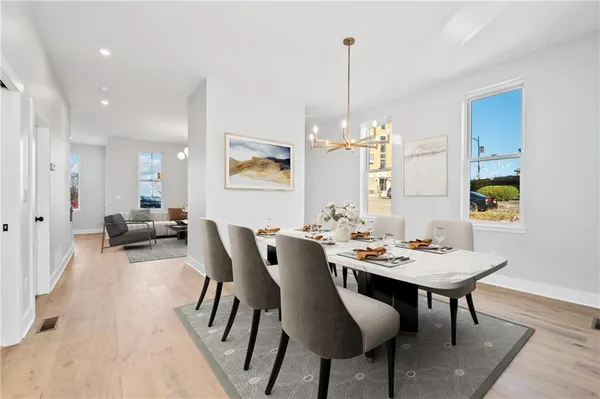 a view of a dining room with furniture and chandelier