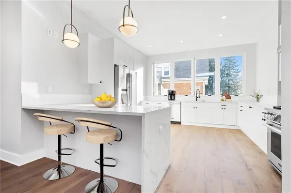 a very nice looking room with wooden floor and windows