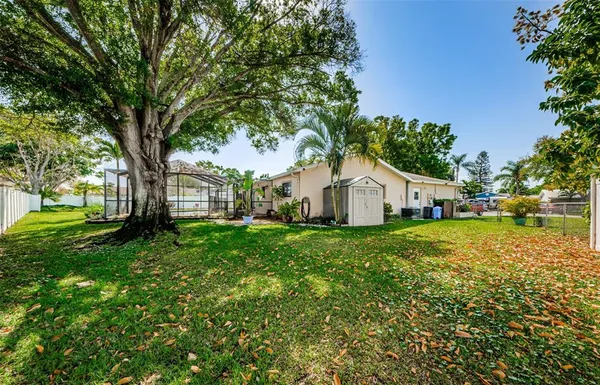 a view of house with backyard and garden