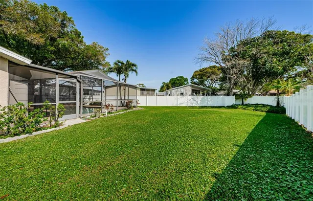 a view of a house with backyard and sitting area
