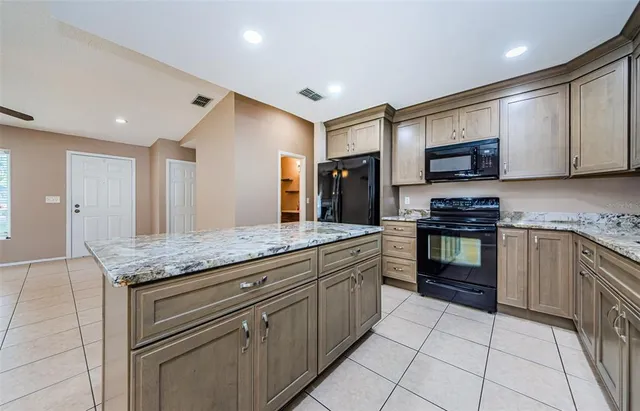 a kitchen with stainless steel appliances granite countertop a stove and a sink