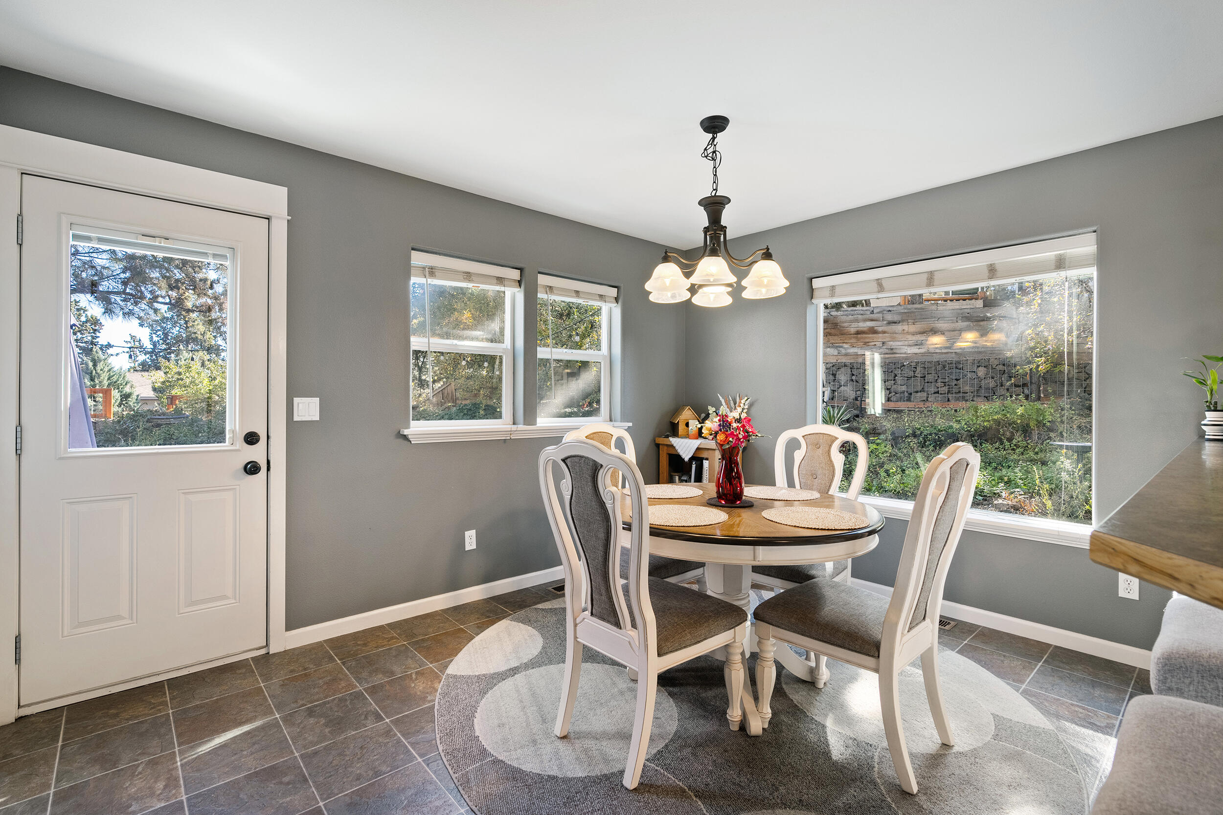 62906 Bilyeu Way Bend, OR 97701 - Photo 62 of 100 a dining room with furniture a chandelier and window