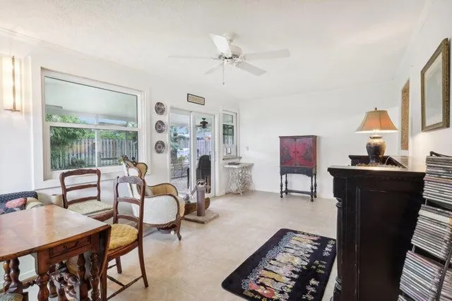a living room with furniture a chandelier and a window