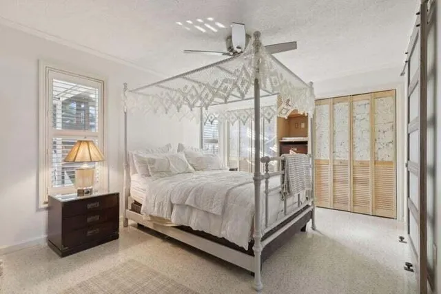 a bedroom with a bed and a chandelier