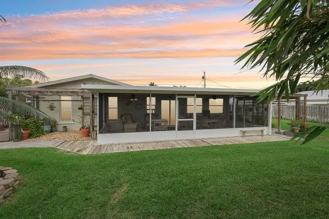 a view of a house with a yard and sitting area