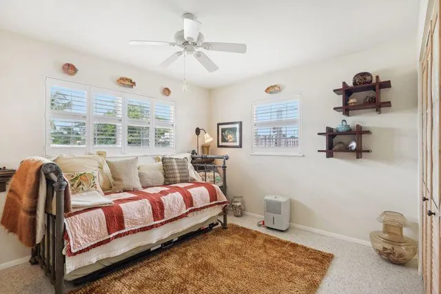 a bedroom with a large bed and a window