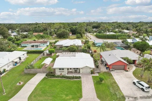 an aerial view of residential houses with outdoor space
