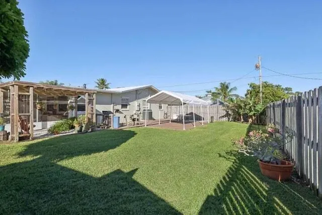 a view of a house with backyard and a sitting area