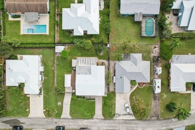 an aerial view of residential houses with outdoor space