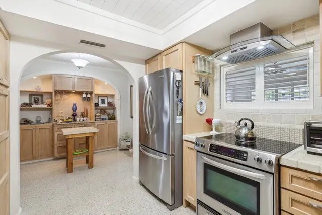 a kitchen with cabinets and stainless steel appliances