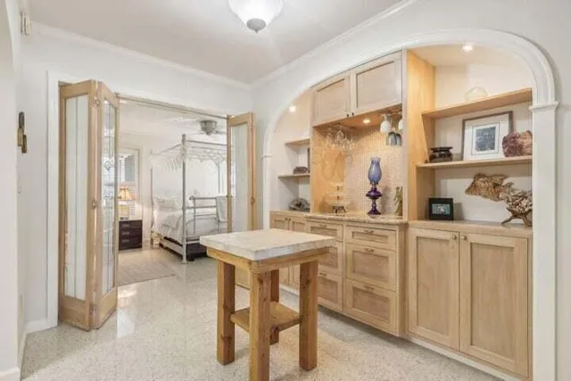 a kitchen with a table chairs refrigerator and cabinets