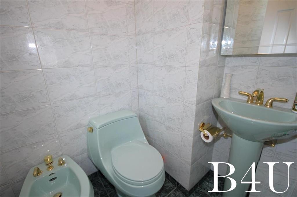 2268 56th Drive Brooklyn, NY 11234 - Photo 12 of 20 a bathroom with a toilet and sink