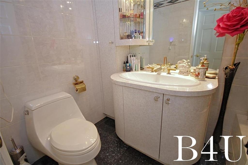 2268 56th Drive Brooklyn, NY 11234 - Photo 14 of 20 a bathroom with a toilet sink and mirror