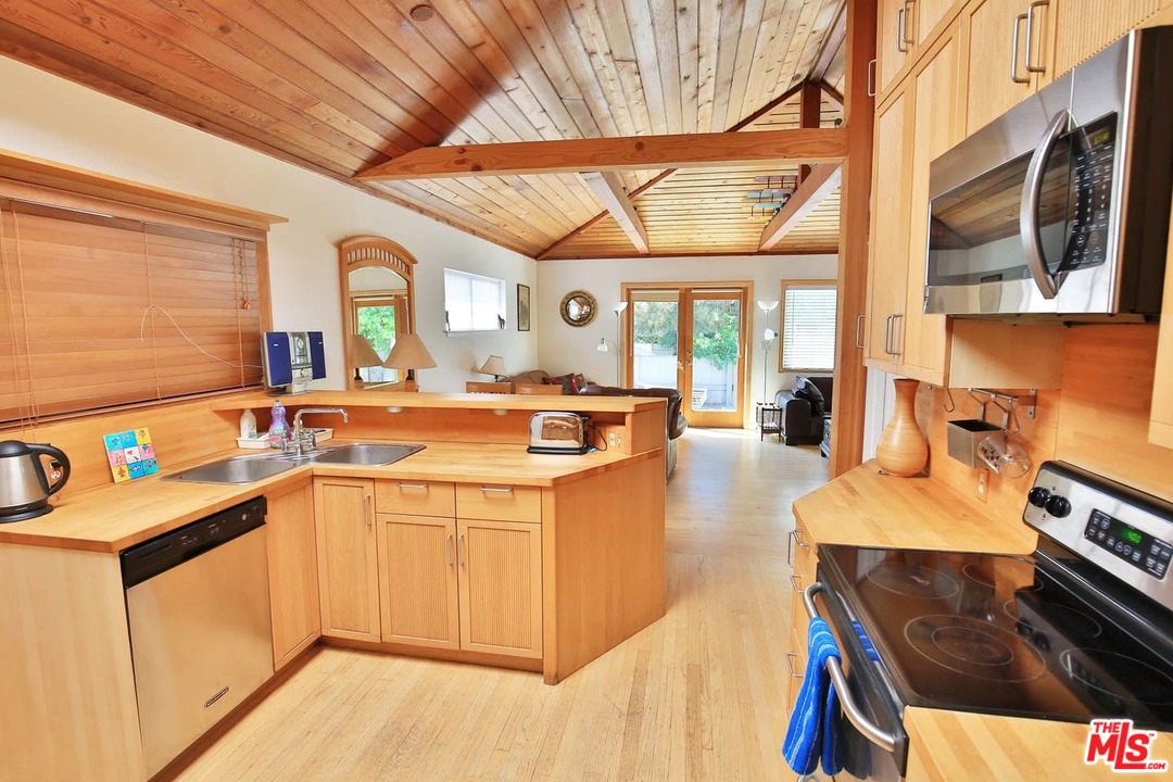 48 Dudley Avenue Venice, CA 90291 - Photo 3 of 16 a kitchen with a sink and a stove top oven