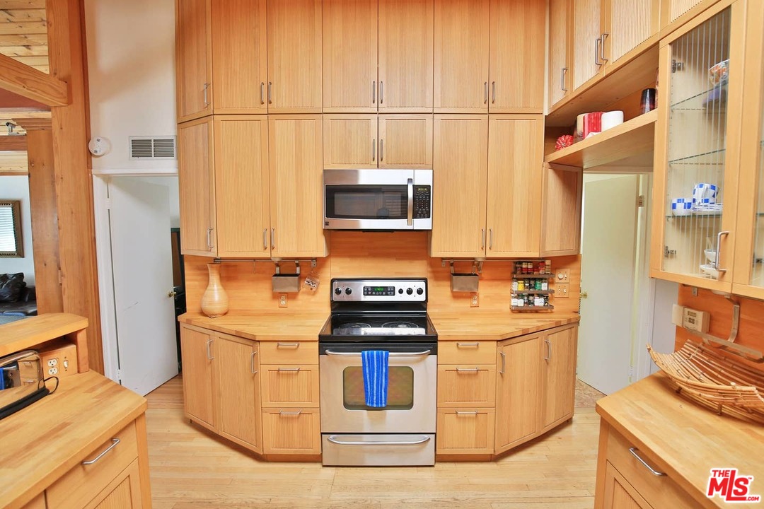48 Dudley Avenue Venice, CA 90291 - Photo 4 of 16 a kitchen with stainless steel appliances granite countertop a stove and a refrigerator