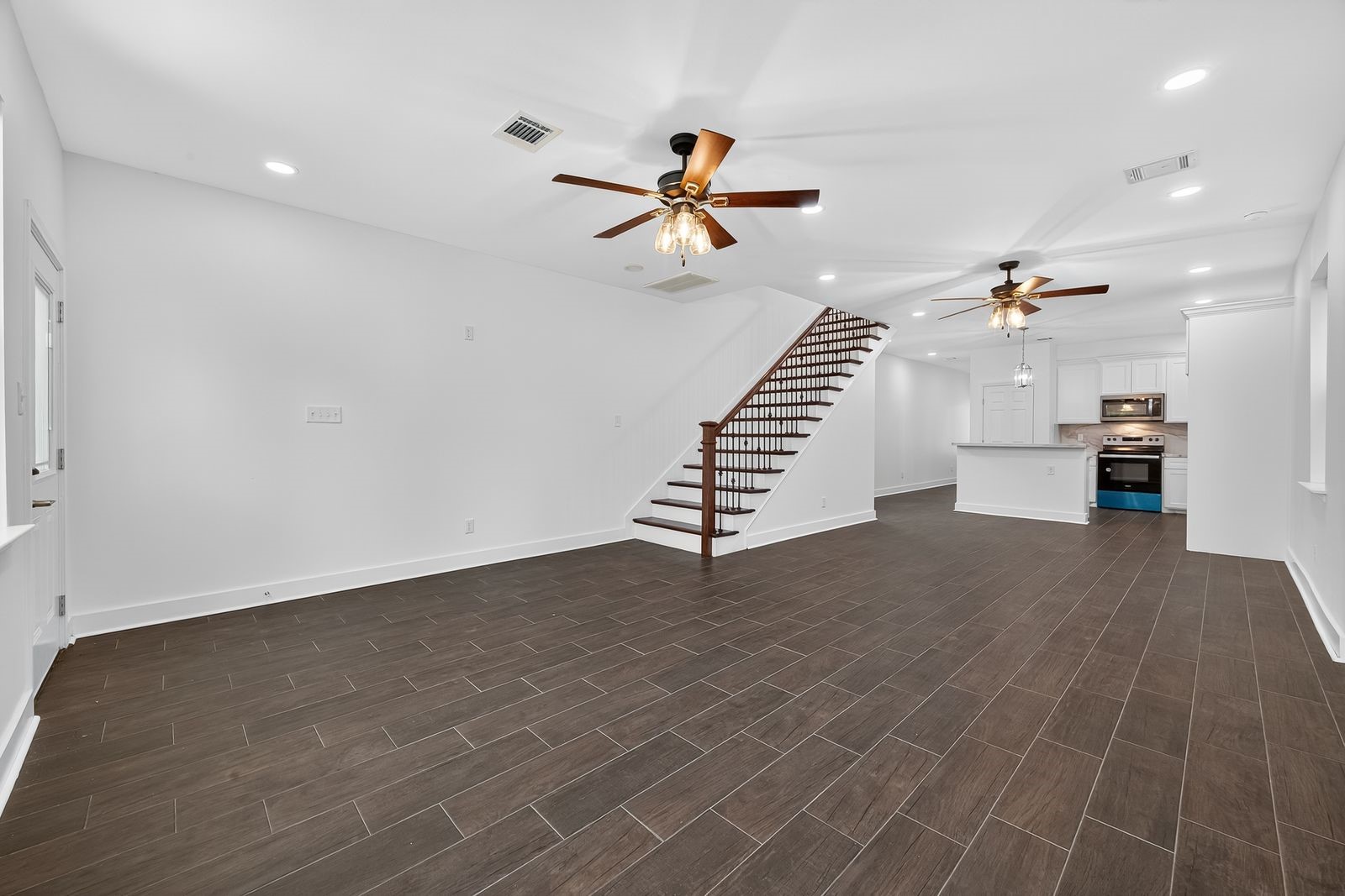 714 Zoe Street Houston, TX 77020 - Photo 11 of 34 an empty room with wooden floor and staircase