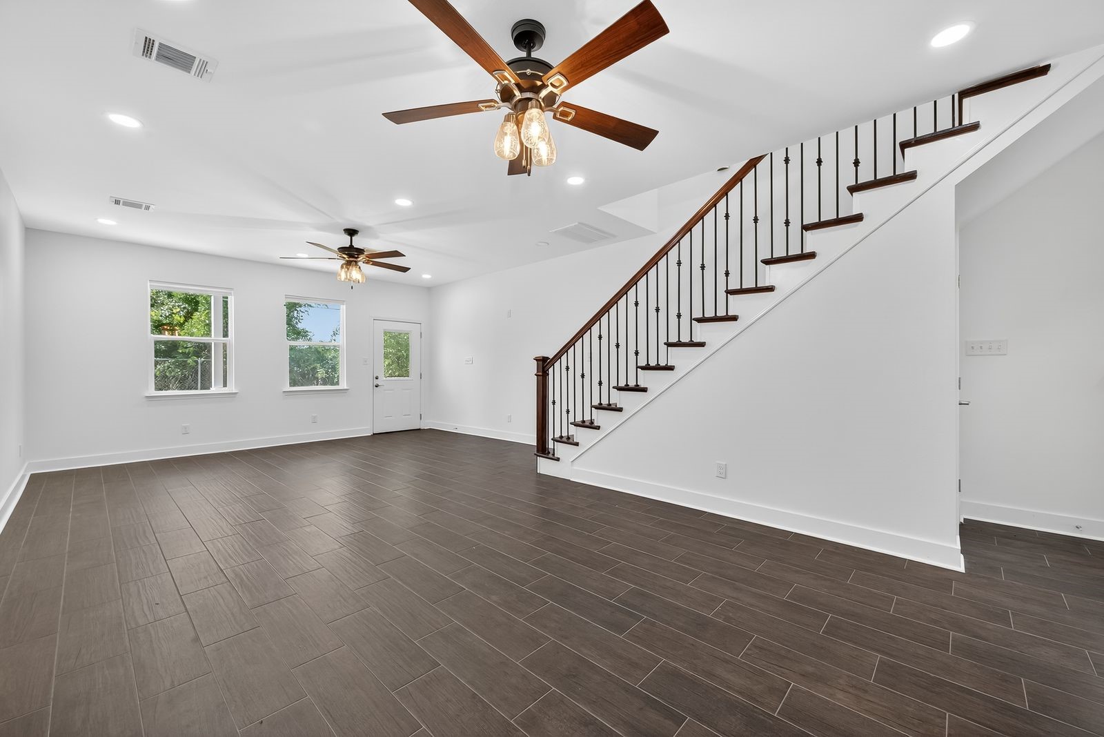 714 Zoe Street Houston, TX 77020 - Photo 13 of 34 an empty room with wooden floor fan and windows