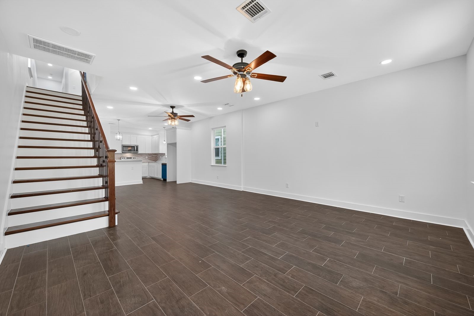 714 Zoe Street Houston, TX 77020 - Photo 14 of 34 wooden floor in an empty room with a ceiling fan