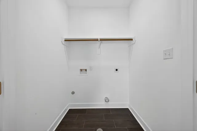 a bedroom with bed and a wooden floor