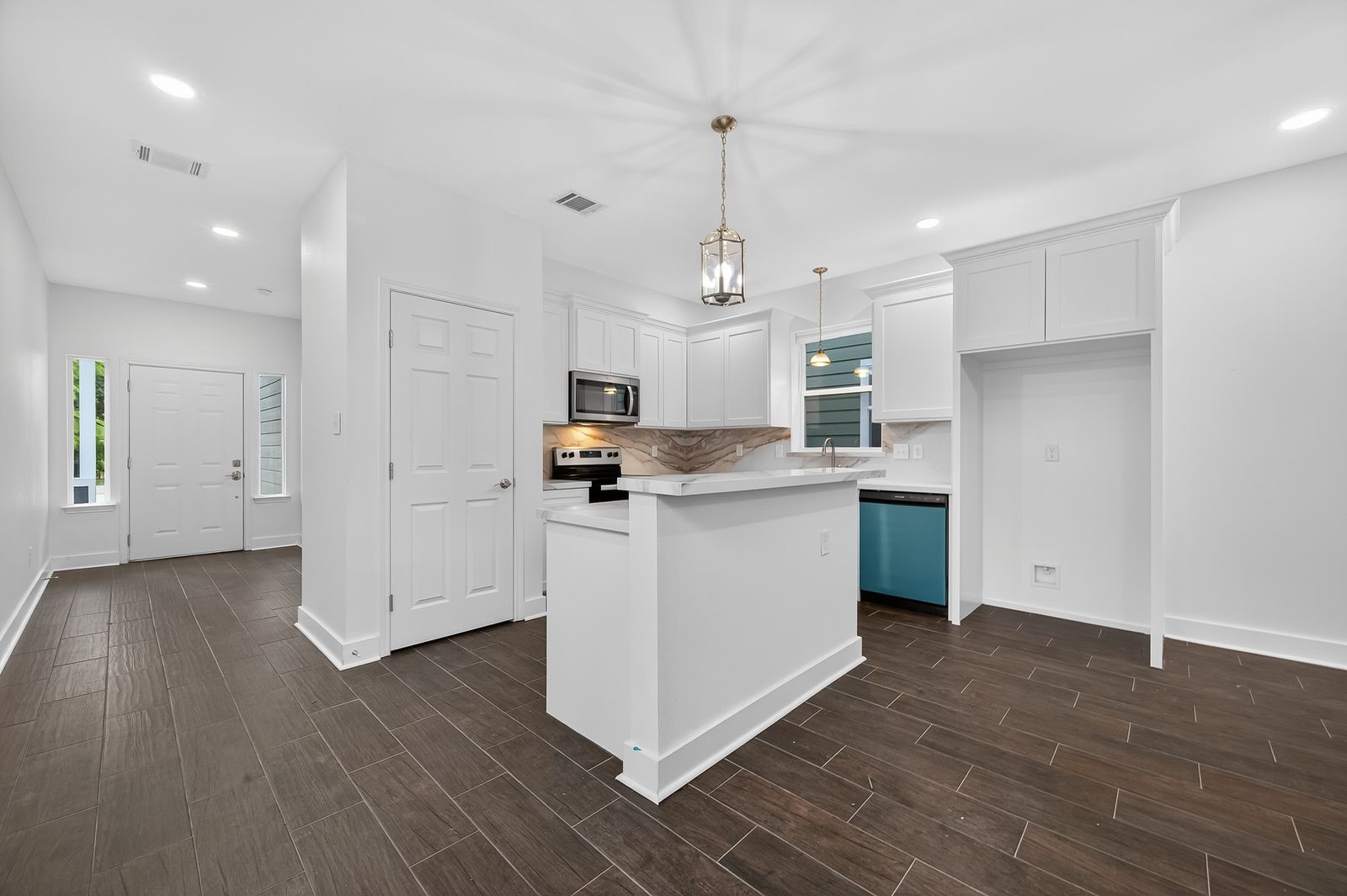 714 Zoe Street Houston, TX 77020 - Photo 3 of 34 a kitchen with stainless steel appliances granite countertop a sink a stove a refrigerator and white cabinets with wooden floor