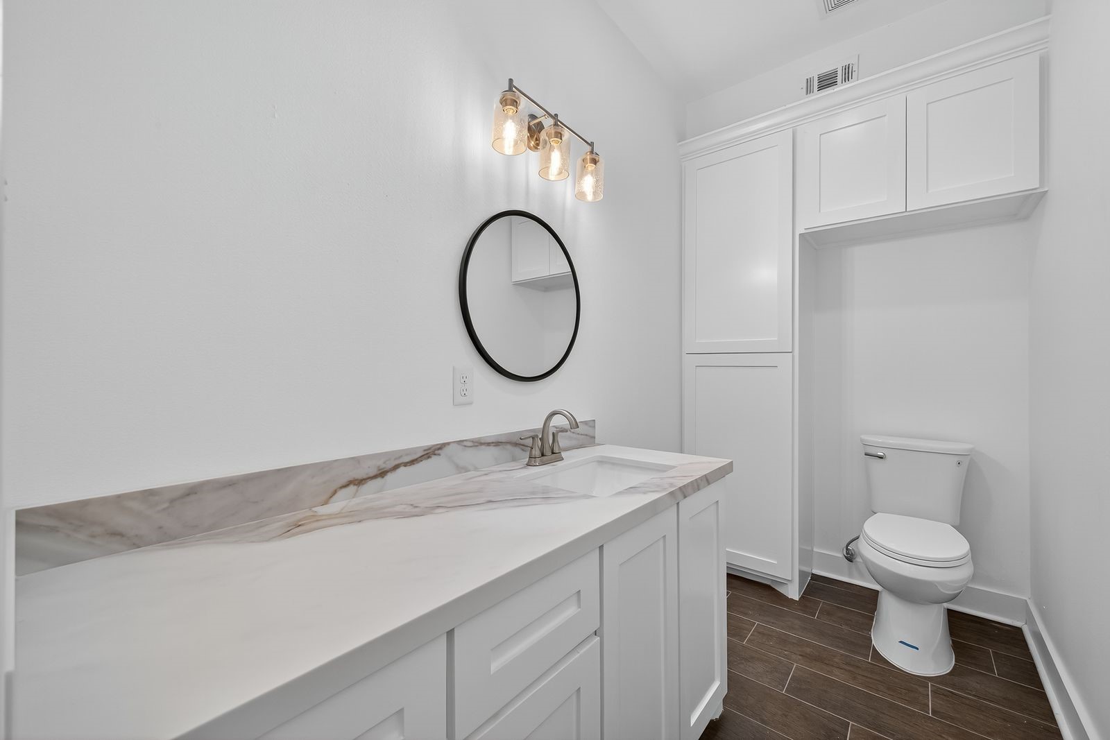 714 Zoe Street Houston, TX 77020 - Photo 6 of 34 a bathroom with a granite countertop toilet sink and mirror