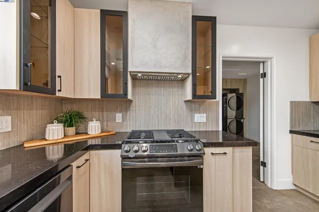 a kitchen with stainless steel appliances granite countertop a stove and a refrigerator