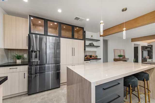 a kitchen with stainless steel appliances a refrigerator sink and cabinets