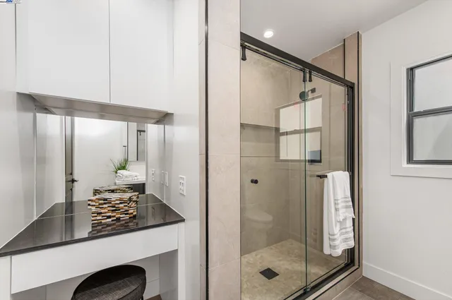 a bathroom with a shower and a sink