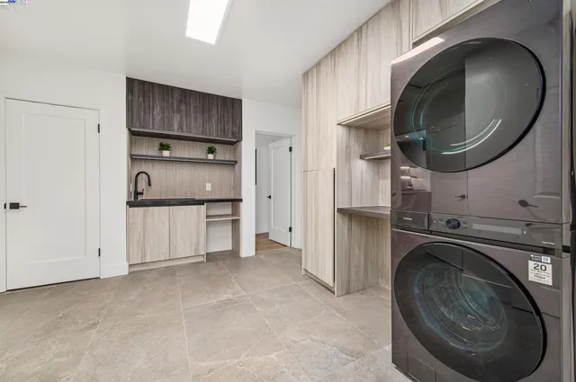 a utility room with cabinets dryer and washer
