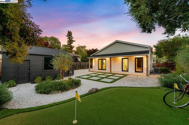 a front view of a house with yard and green space