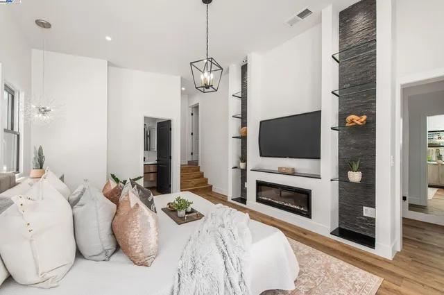 a spacious bedroom with a bed and a flat screen tv